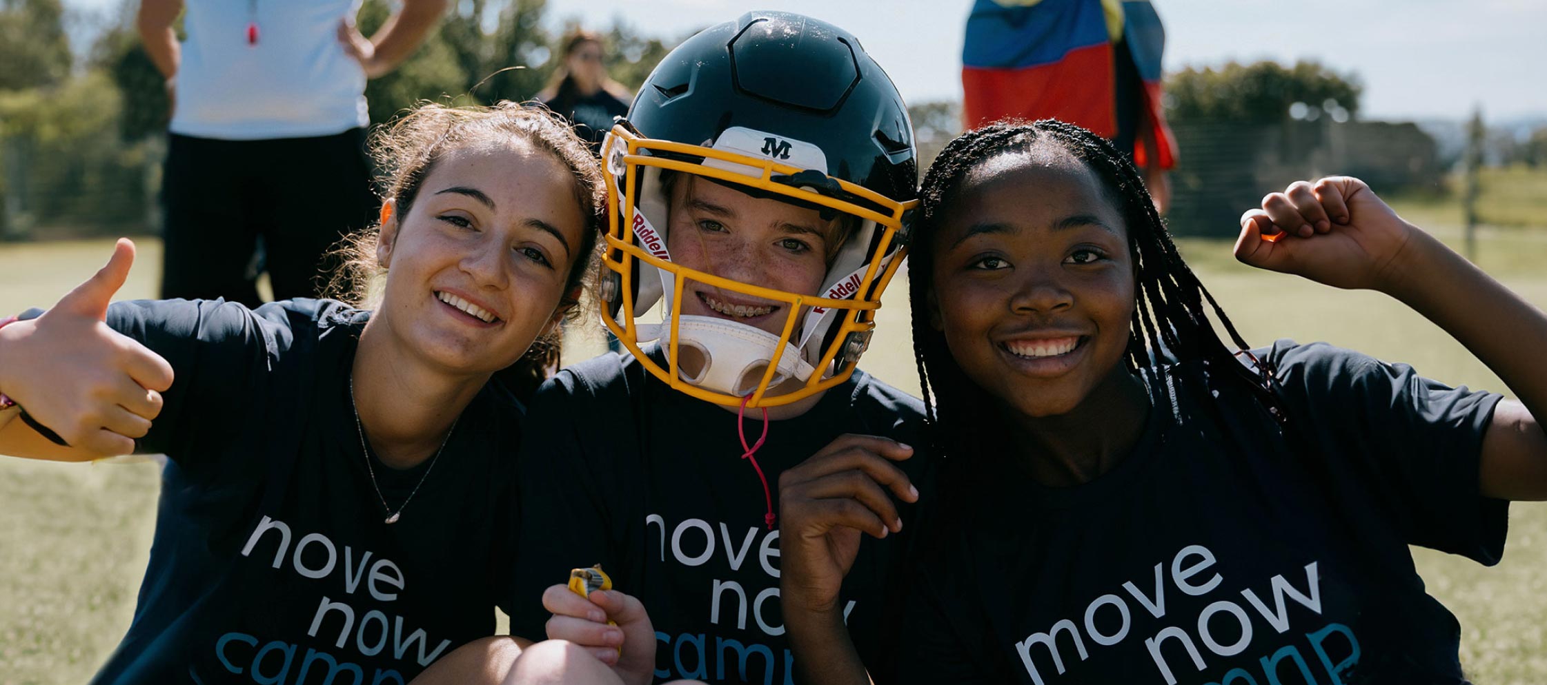 Three young participants of the global edition MoveNow camp looking happily